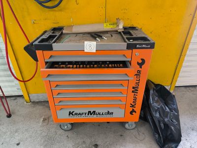 a small orange tool box with tools in it