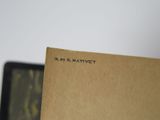 a picture of a book on a table with a laptop in the background