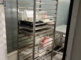 a metal rack with trays on it in a kitchen