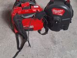 two milwaukee tools are sitting on the floor next to each other