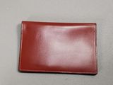 a brown leather wallet sitting on top of a table