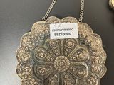 a silver plate with a tag on it sitting on a table