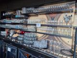 a bar with a lot of glasses on the shelves