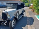 a vintage car parked on the side of the road