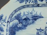 a blue and white plate with a picture of a boat on it