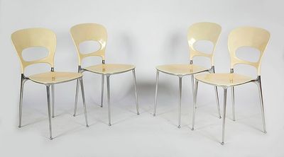 four yellow chairs sitting next to each other on a white surface