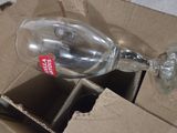 a empty wine glass sitting in a box on the floor