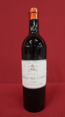 a bottle of red wine sitting on top of a red table