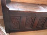 a wooden bench with carvings on it in a room