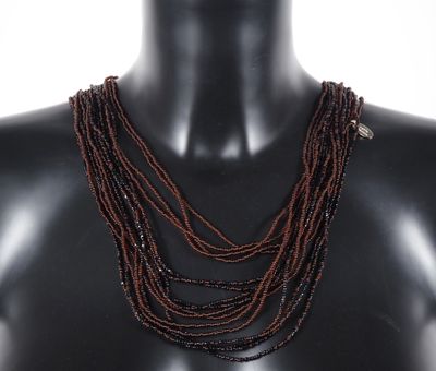 a close up of a mannequin with multiple strands of beads