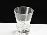 a clear glass sitting on top of a white table