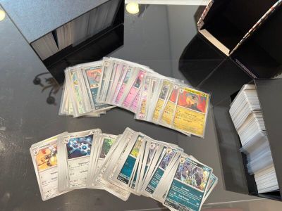 a lot of cards on a table with a black case
