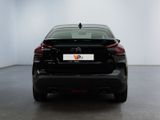 the rear end of a black car in a white room
