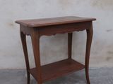 a small wooden table with a shelf on top of it