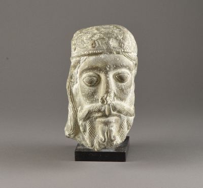 a white marble head of a man with a beard and a hat