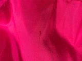 a close up shot of a bright pink satin fabric