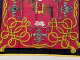 a picture of a red and yellow scarf with a picture of a man on a horse