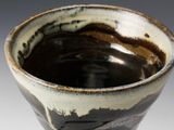 a close up of a brown and white bowl
