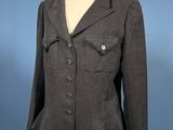 grey jacket on a mannequin base on a blue background