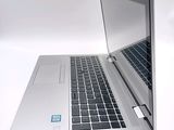a silver laptop with a blue sticker on the screen