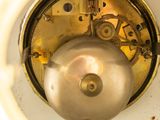 a close up view of a clock with a pendulum on it