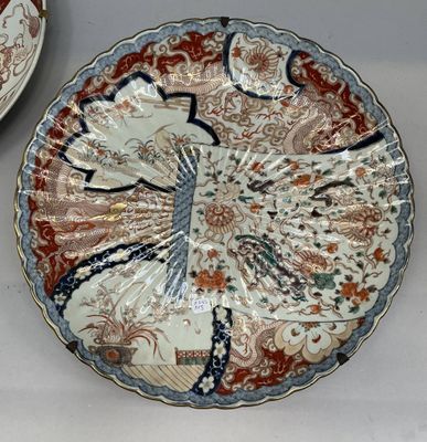 two plates with designs on them sitting on a table
