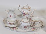 a tray with a tea set on it and a cup and saucer on the tray