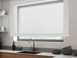 a kitchen with a sink and a window with blinds on it