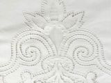 embroidery design on a white sheet with a decorative design