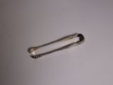 a small metal object on a white surface