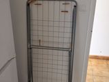 a metal gate in the corner of a kitchen