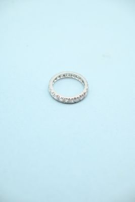 a close up of a diamond ring on a blue surface