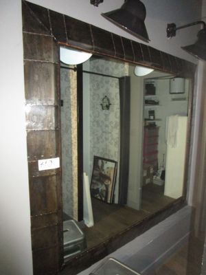 a bathroom with a sink and a mirror in it