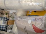 many rolls of fabric on the shelf in the room