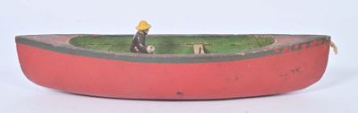 a red boat with a man sitting in it