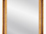 un miroir encadré d'or sur fond blanc