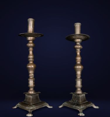 a pair of antique brass candlesticks