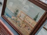 une photo d'un tableau posé sur un banc dans une pièce
