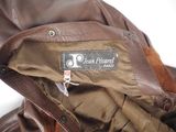 brown leather jacket with a label on the back of it