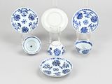 a group of blue and white plates and bowls