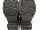 the soles of a pair of black shoes on a white surface