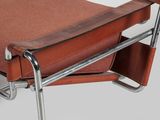a brown leather chair with metal legs and a brown seat