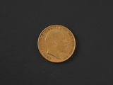 a close up of a gold coin on a black surface