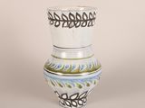 a white vase with a blue and green design on it