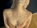 a statue of a woman that is sitting on a table