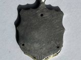 a close up of a metal object on a white surface