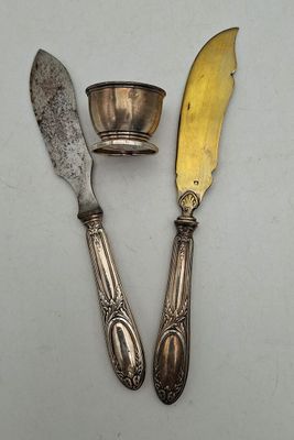 two knives and a bowl on a table