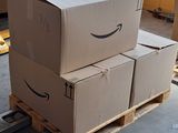 boxes stacked on a pallet in a warehouse with a laptop on top of them