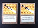 two cards with a sword on them on a table