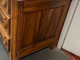a wooden dresser with a mirror on top of it